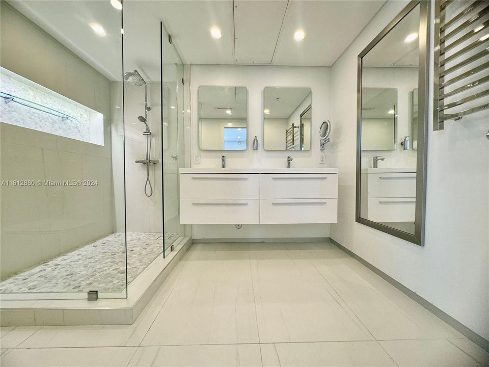 Full Bathroom with dual vanity and stand-up glass shower