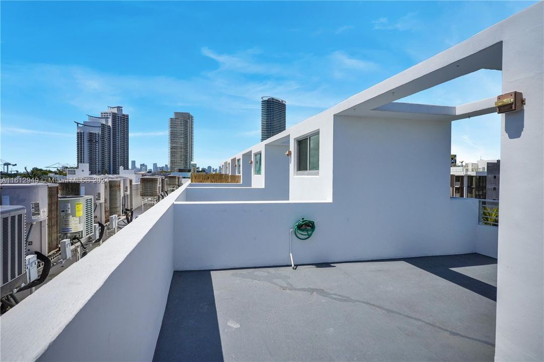 Bright, airy private rooftop patio with stunning city views. Perfect for relaxation and entertaining.