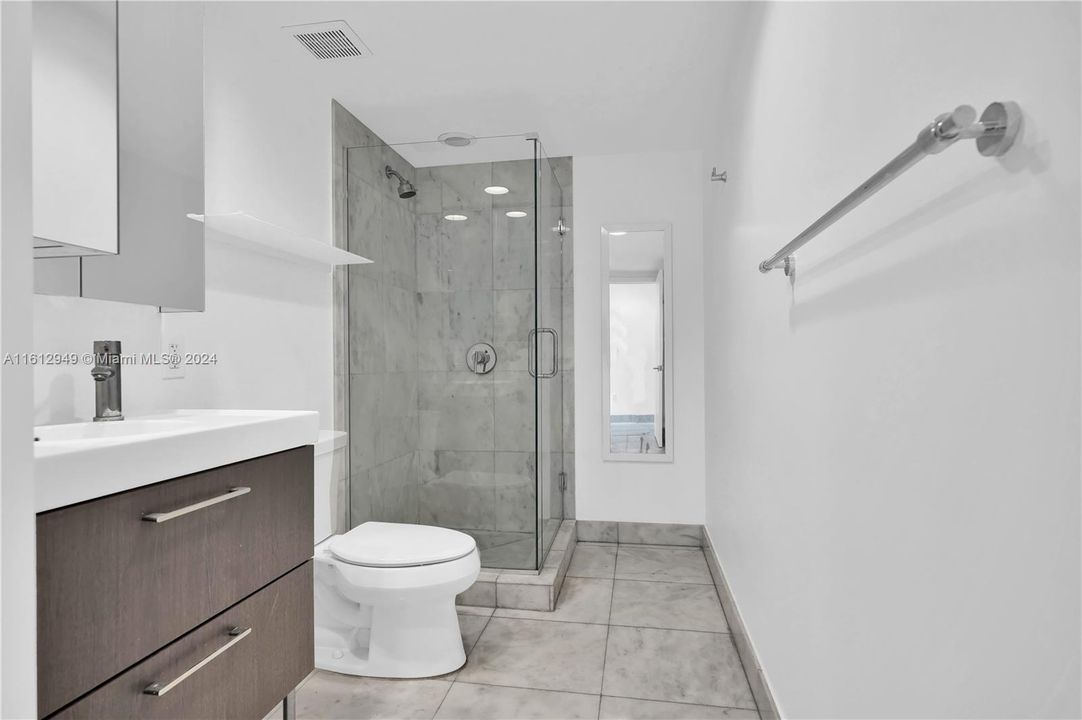 Bathroom No.2: Modern bathroom with glass-enclosed shower, sleek fixtures, and tiled flooring.