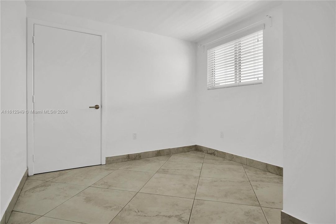 Bedroom No. 2 - with tiled flooring, a window for natural light, and a clean, modern design.