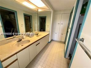 Double sinks, walk in closet, shower and storage