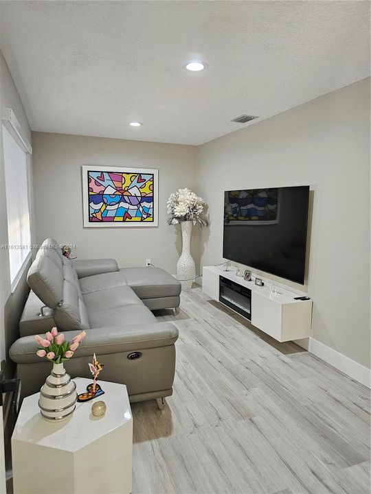 4th bedroom with closet being used as a cozy family room