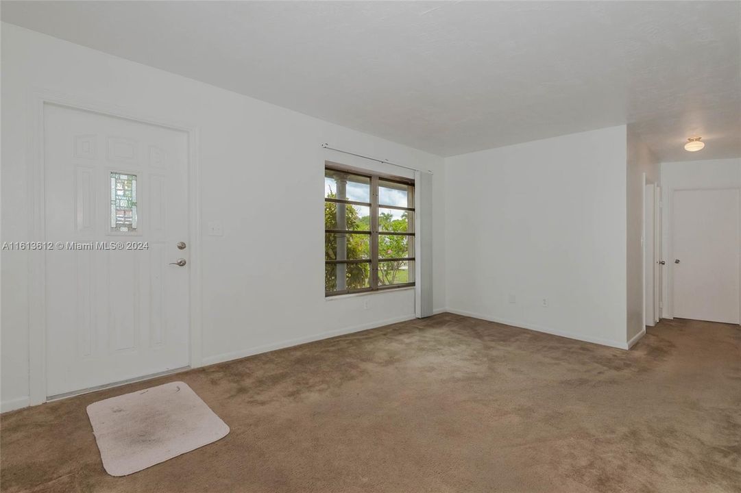 Front door with double wide window for plenty of light into the living room area.  The door on the right goes into the bedroom areas.