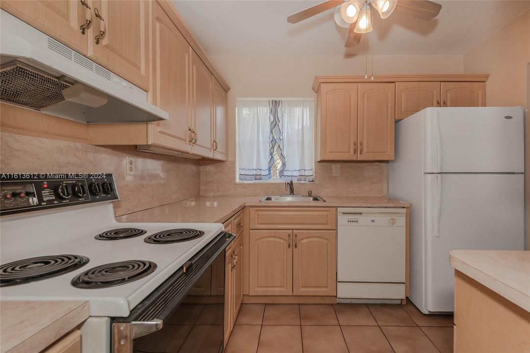 The kitchen has a lot of storage space in the many cabinets.