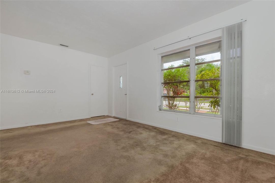 Another look at the spacious living room area and outside view.