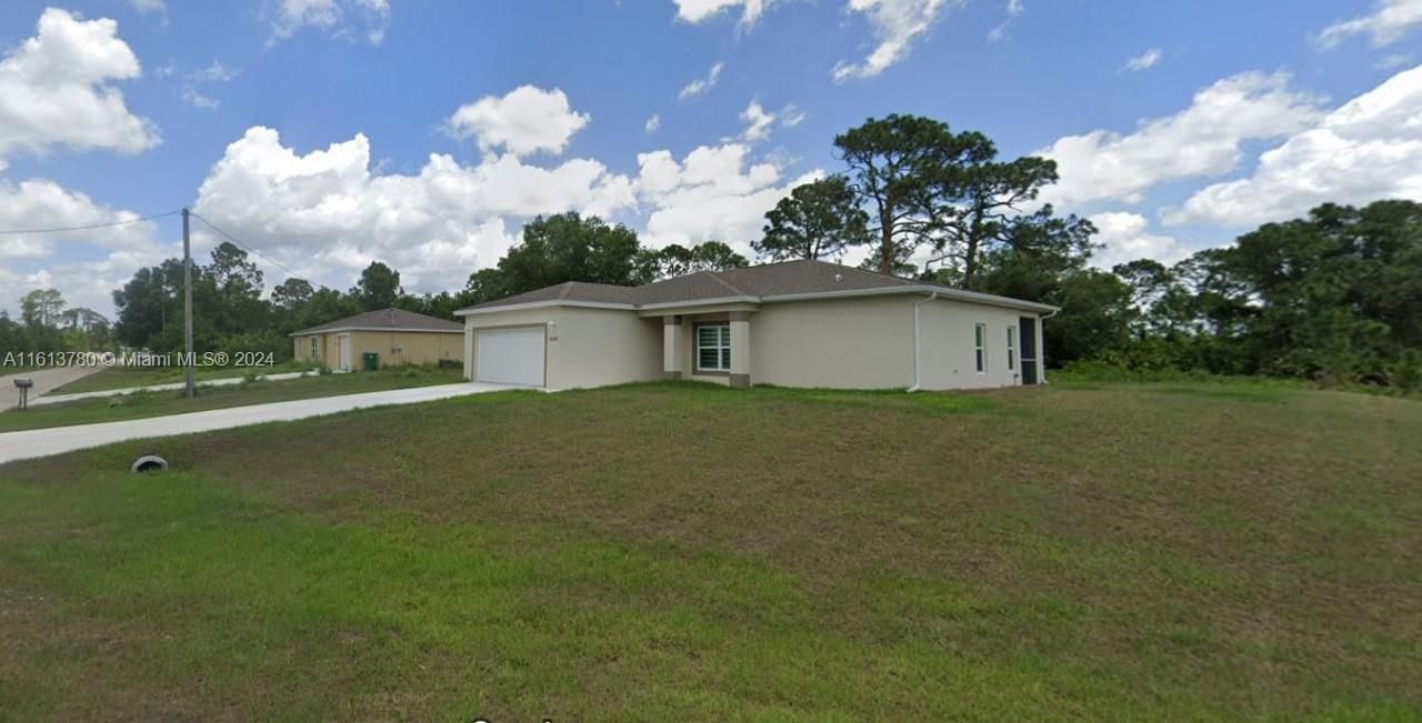 Single-family home located on a tranquil corner lot in Kumquat Circle, Port LaBelle, boasting 3 bedrooms and 2 baths.