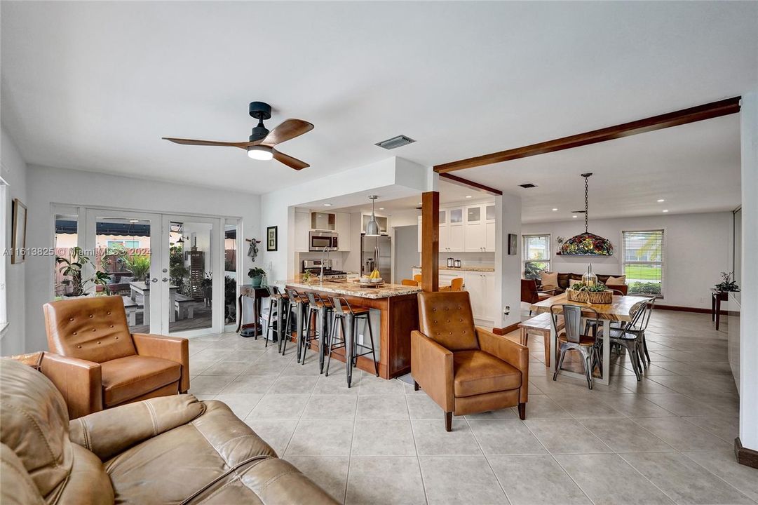 Family Room flows into Kitchen and Dining area - double doors that open towards the covered patio and pool area