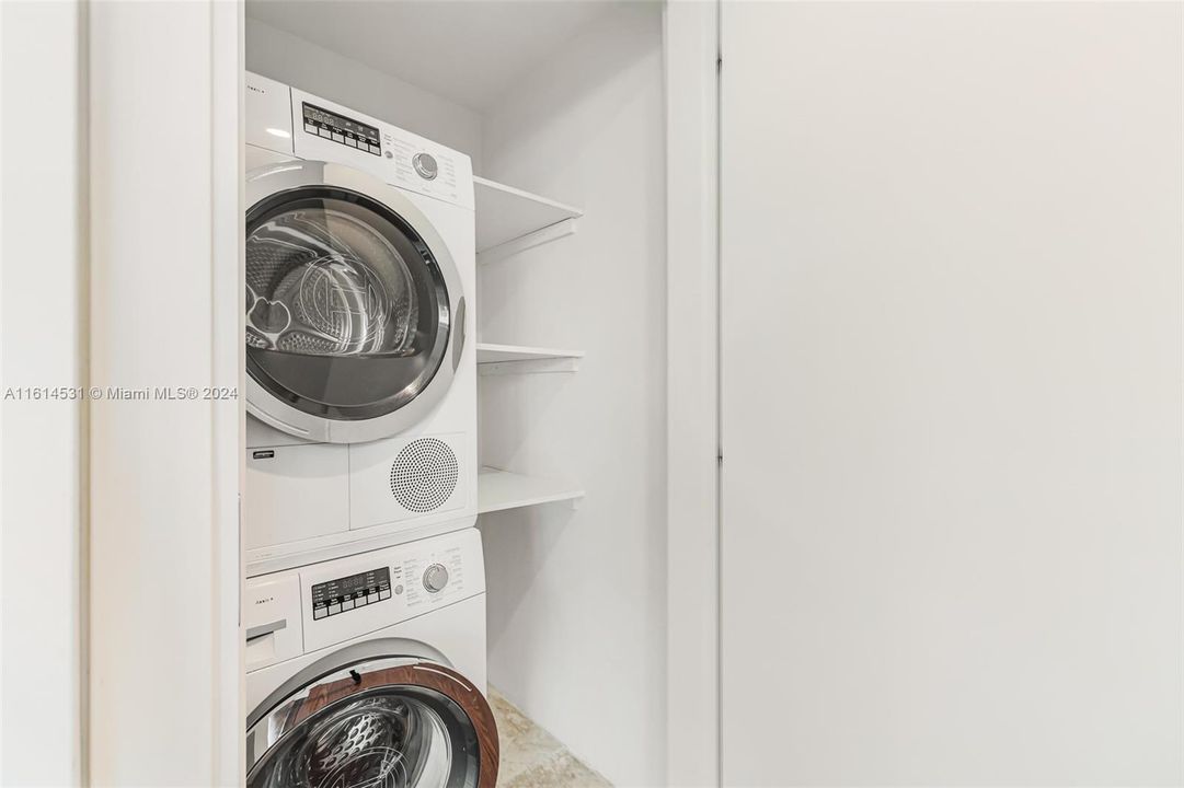 Laundry closet with storage shelves