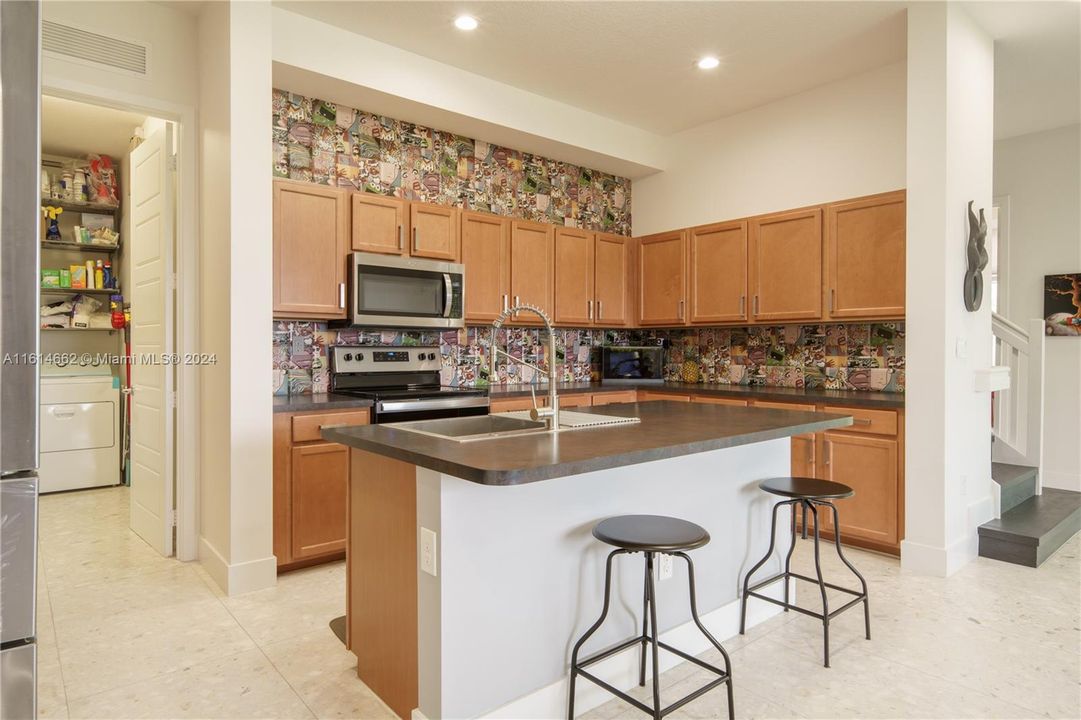 Kitchen with View of Pop Art of Comic Strips as Backsplash