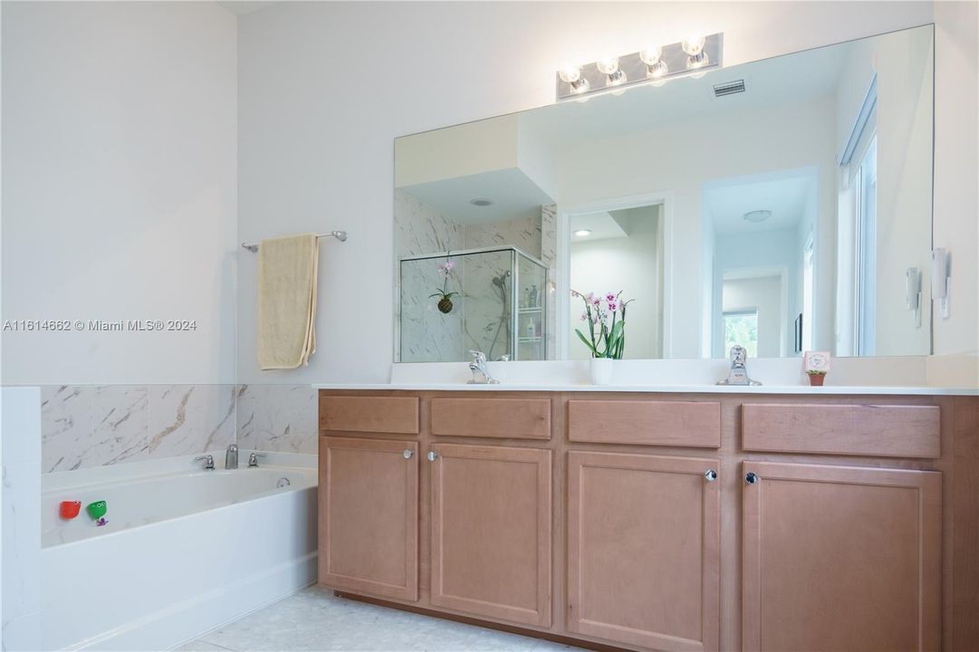 Dual Sinks in Master Bathroom with Tub and Separate Shower