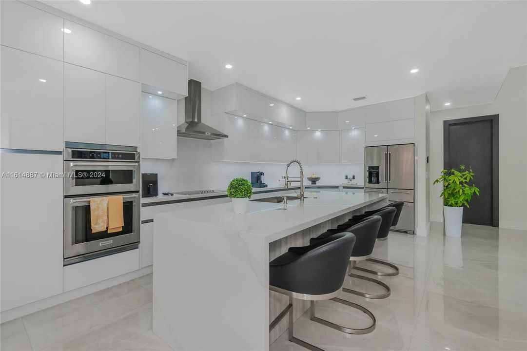 waterfall island with beautiful quartz counter tops