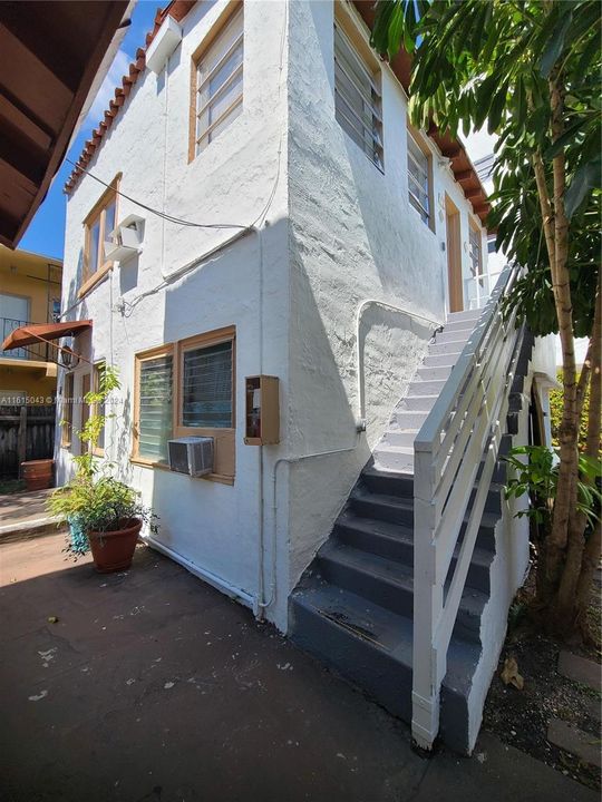 Cottage in the back: stairs to unit 7, a 1/1 on the 2nd floor.