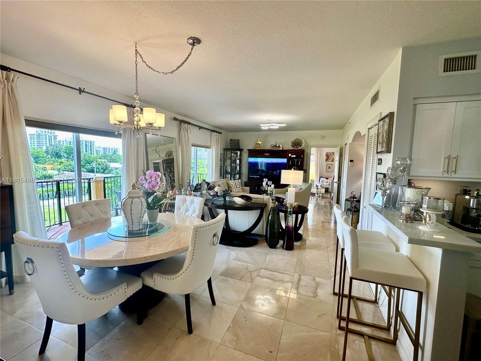 DINING, LIVING AND EAT-IN KITCHEN WITH MARBLE FLOORS THROUGHOUT FACING AN EXTRA LARGE BALCONY