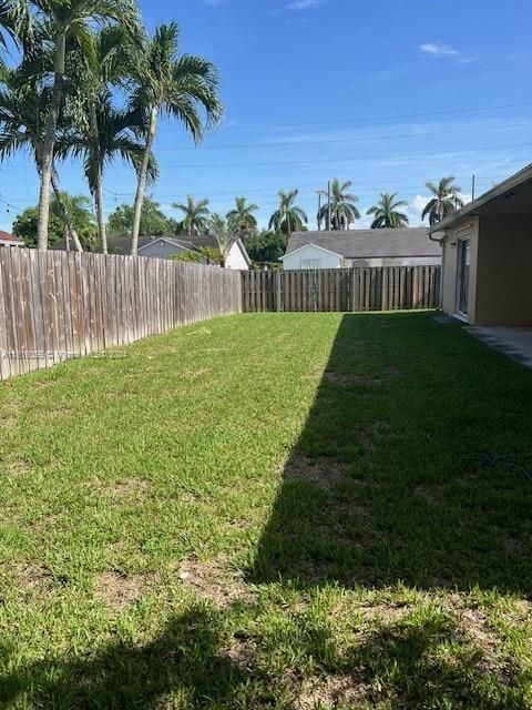 View of yard entrance to yard wood fence