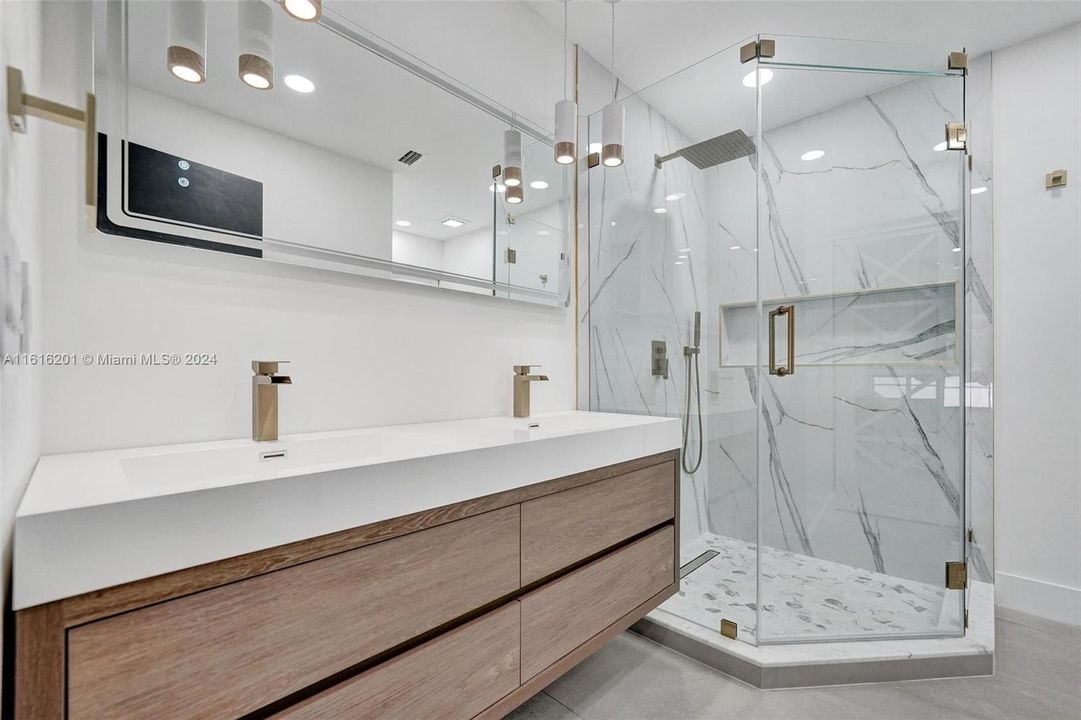 All new. LED lighting in mirrors. Large shower. Vanity has double sinks, large drawers. Oversized gorgeous shower.