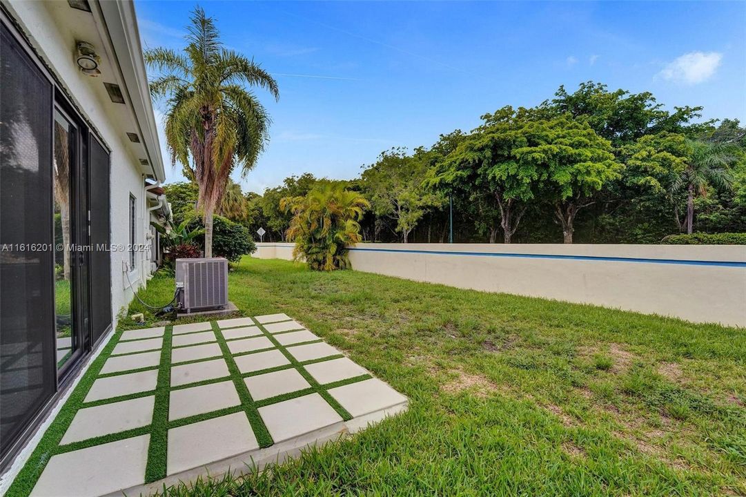 Back patio. Note community shrubbery against wall purchased to provide privacy.