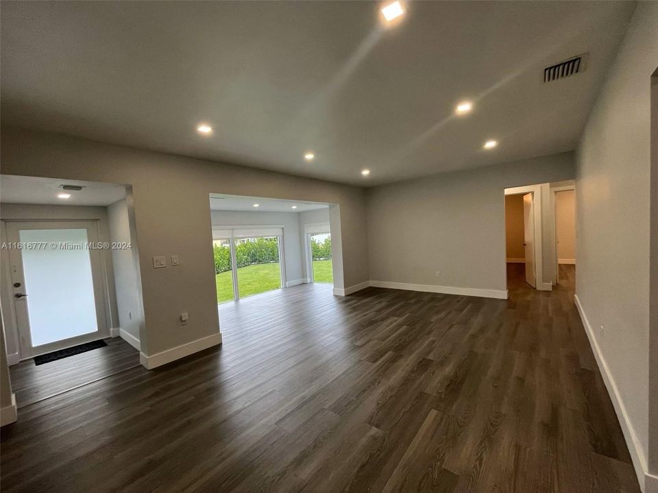 Door to the left is the front door, hallway to the right leads to 2 bedrooms and hallway bathroom