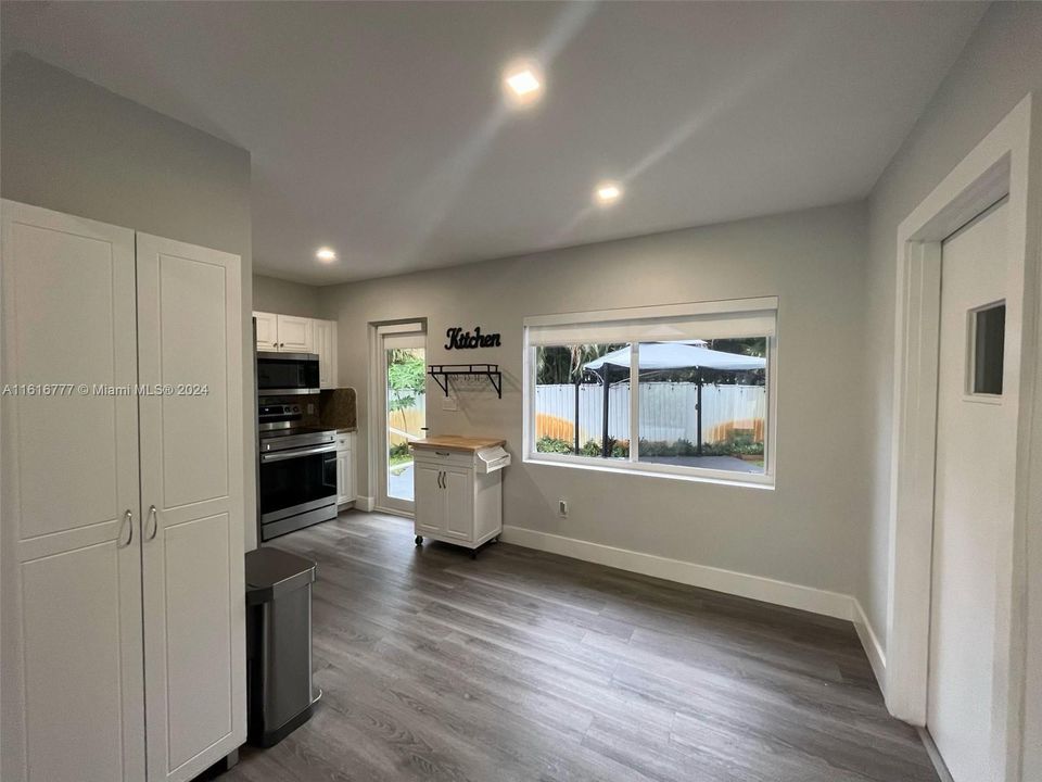 Dinning room area, Door to the right leads to the laundry room, glass door in the back leads to backyard