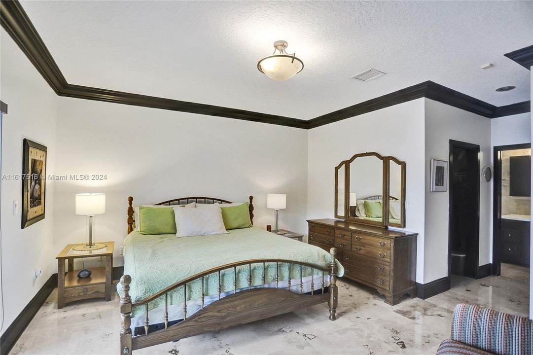 THE DOWNSTAIRS BEDROOM WITH FRENCH DOORS TO PATIO & POOL