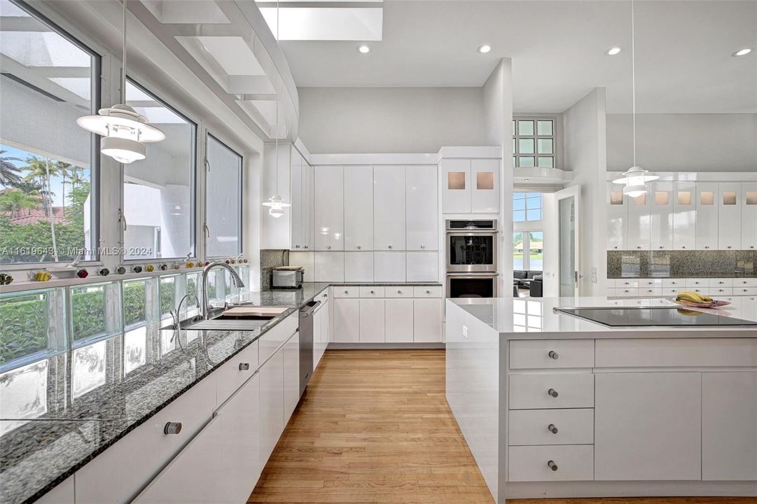 The recently renovated kitchen, featuring top-of-the-line appliances, a white waterfall quartz island, and Sub-Zero refrigeration, is a chef’s dream.