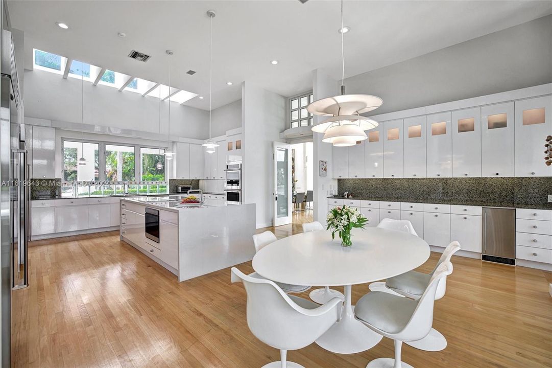 The recently renovated kitchen, featuring top-of-the-line appliances, a white waterfall quartz island, and Sub-Zero refrigeration, is a chef’s dream.