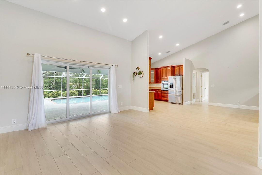 Great room opens to covered/screened pool area