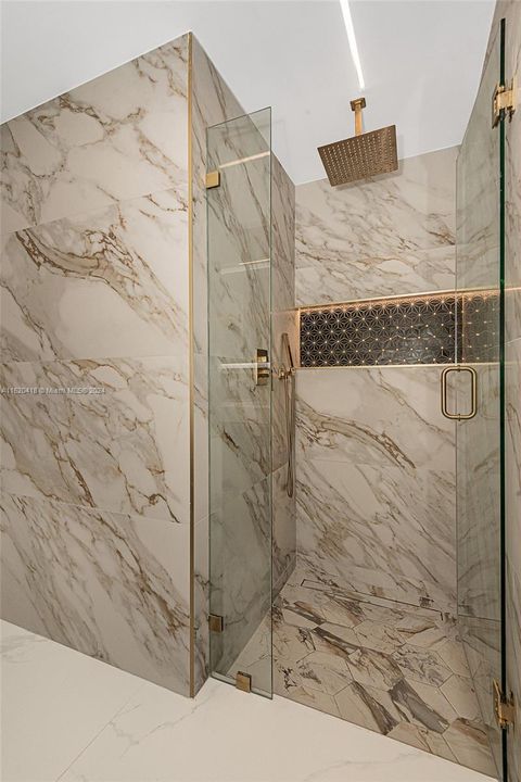 Floor to ceiling, gold calacatta porcelian