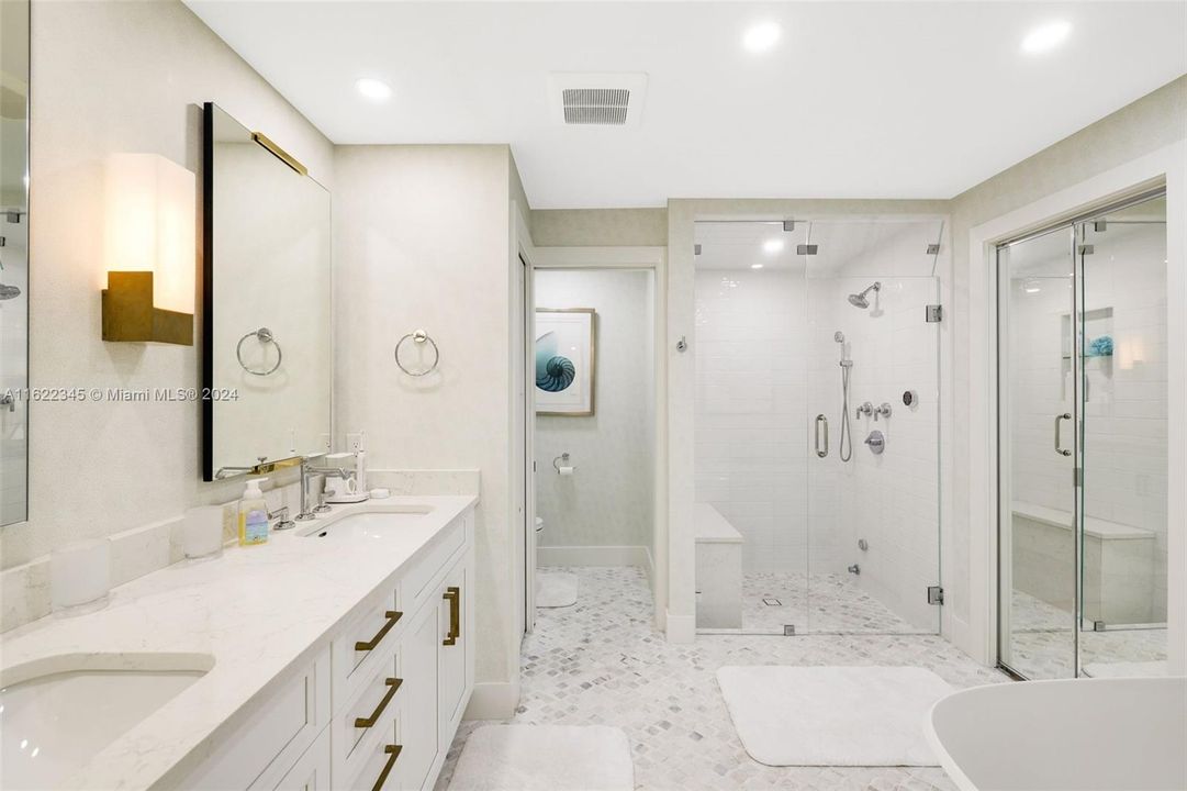 Primary Bath with dual sinks and walk-in steam shower with bench seat