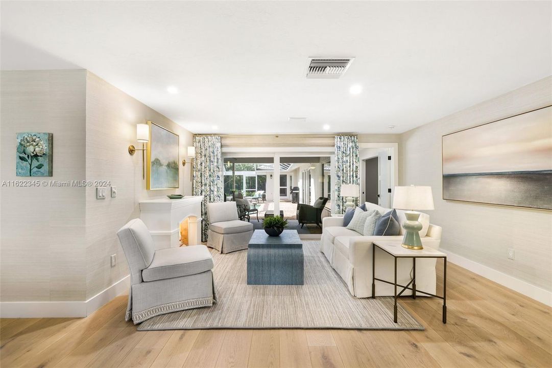 Main living area overlooking outdoor living and pool area