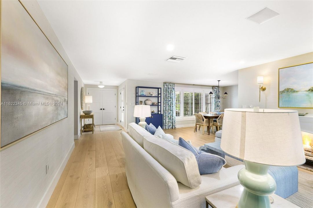 Main Living/Dining looking back into Foyer/Entry showcasing white oak hardwood floors throughout home