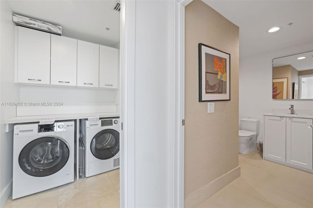 separate laundry area with side by side washer and dryer