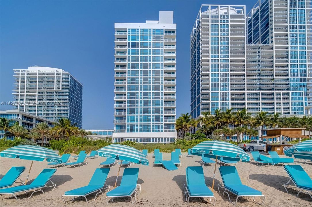 Resident beach club right outside your door, which includes chairs, umbrellas, towel service, and food and beverage service