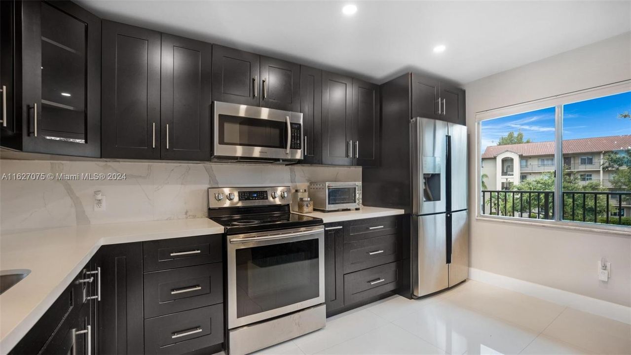 Stainless Steel Appliances and Real Wood Cabinets