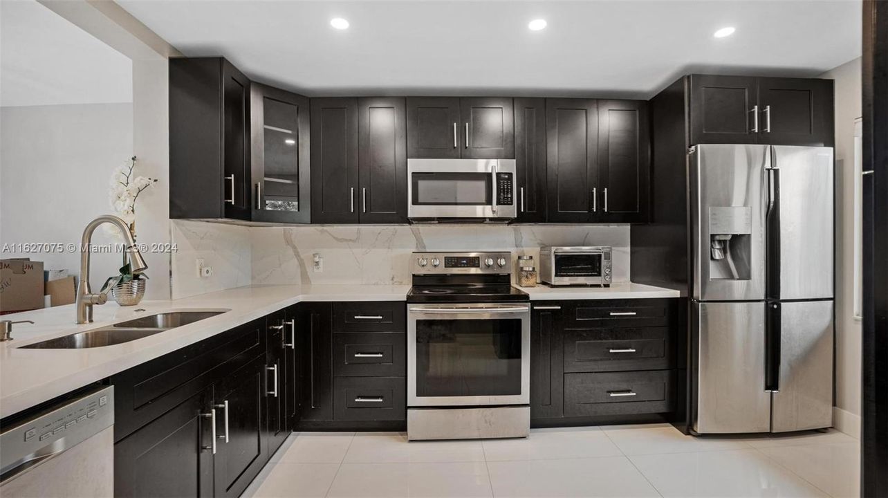 Stainless Steel Appliances and Real Wood Cabinets