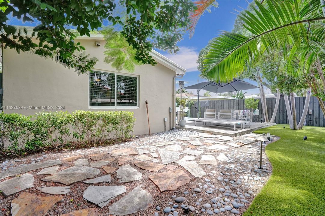 Back of the house, enclosed yard with low Maintanence artificial turf.