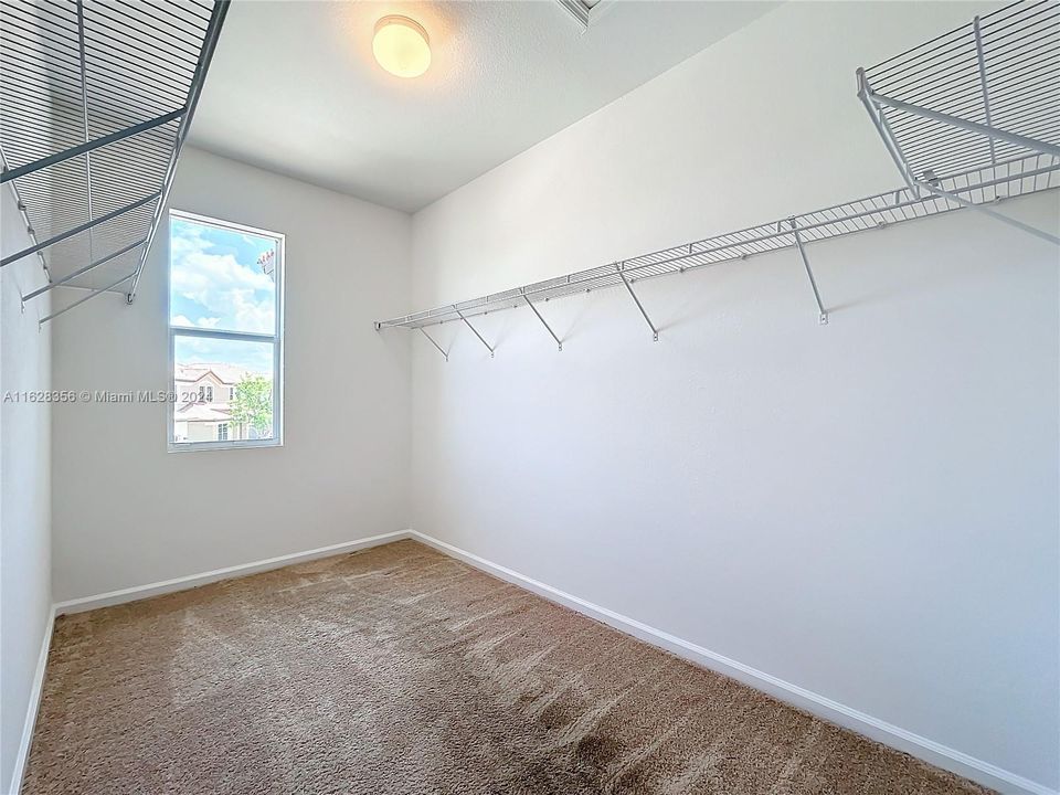 Primary bedroom walk in closet