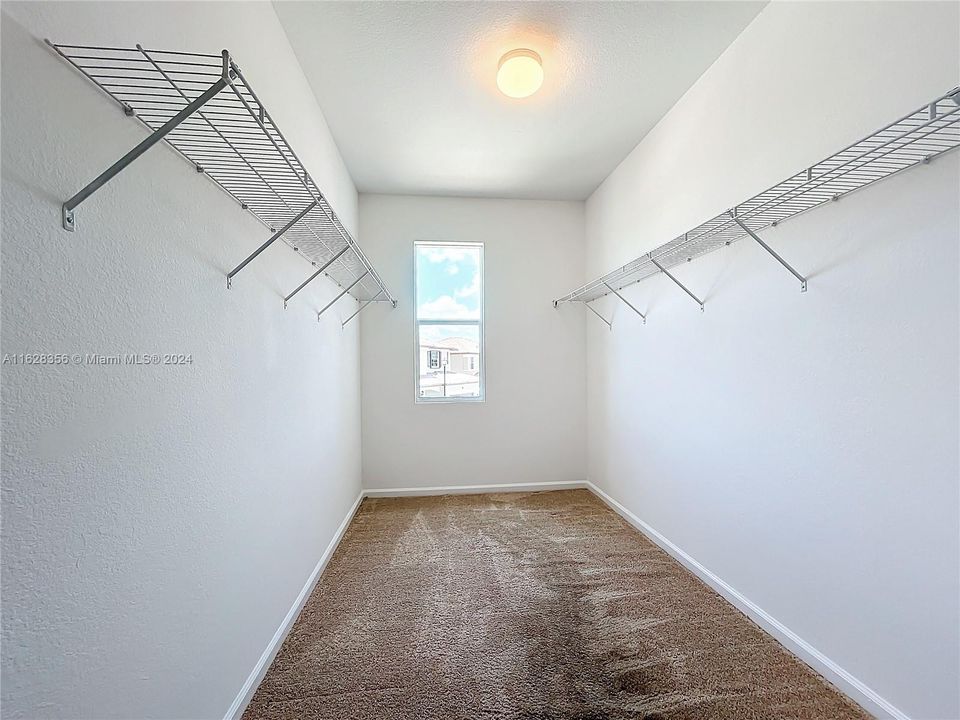 Primary bedroom walk in closet