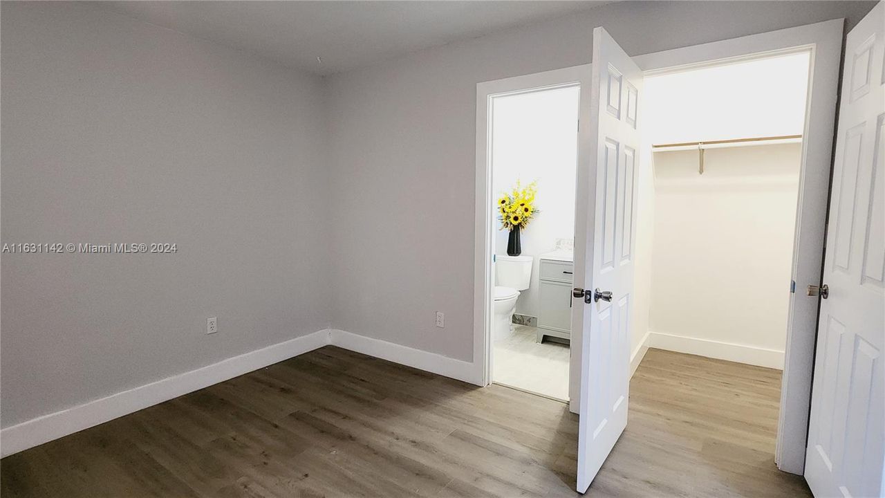 Approach to primary bathroom and walk-in closet