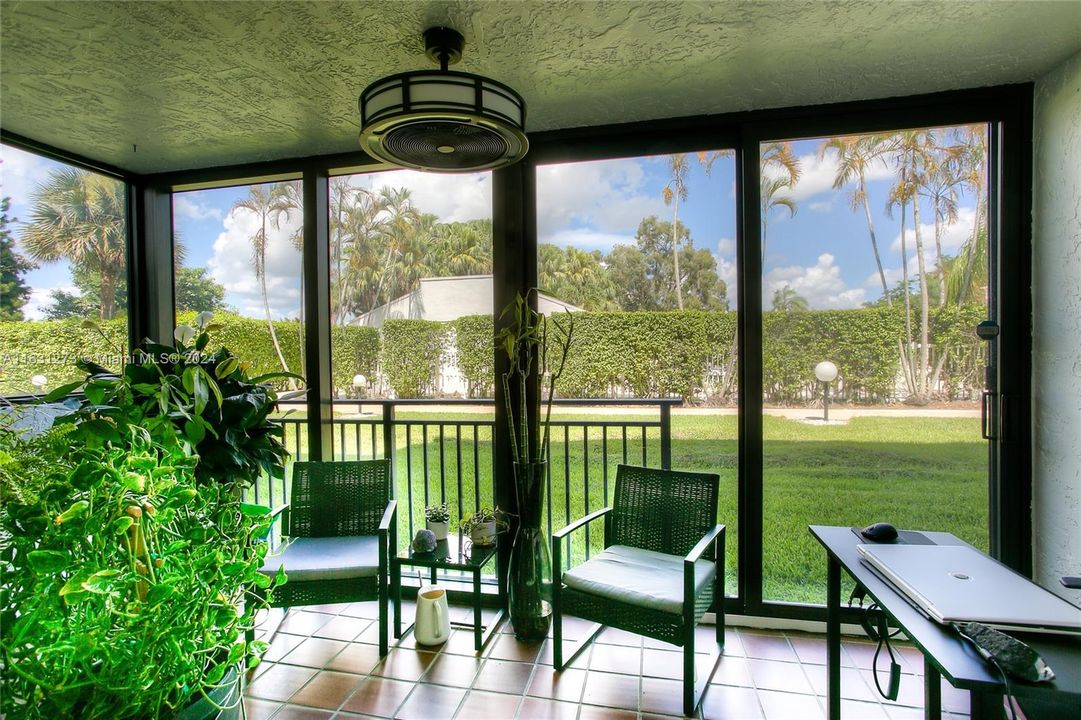 Hurricane Impact Sliding Doors protecting the sunroom that's steps away from pool