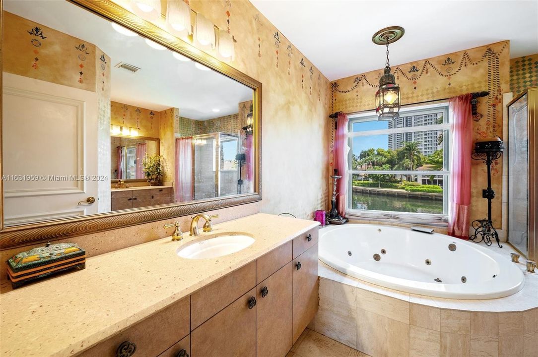 Primary bath with more than enough room for two, whirlpool tub, shower, and dual vanities.