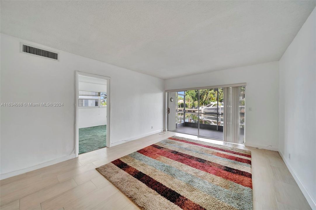 Living area with door leading to Primary Bedroom