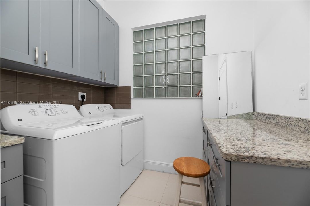 Upgraded laundry room with built in cabinets