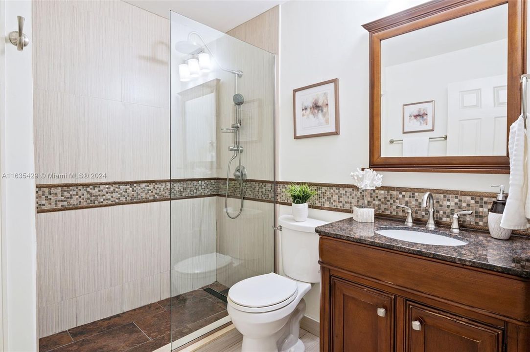 Secondary Bath w/ frameless shower enclosure.