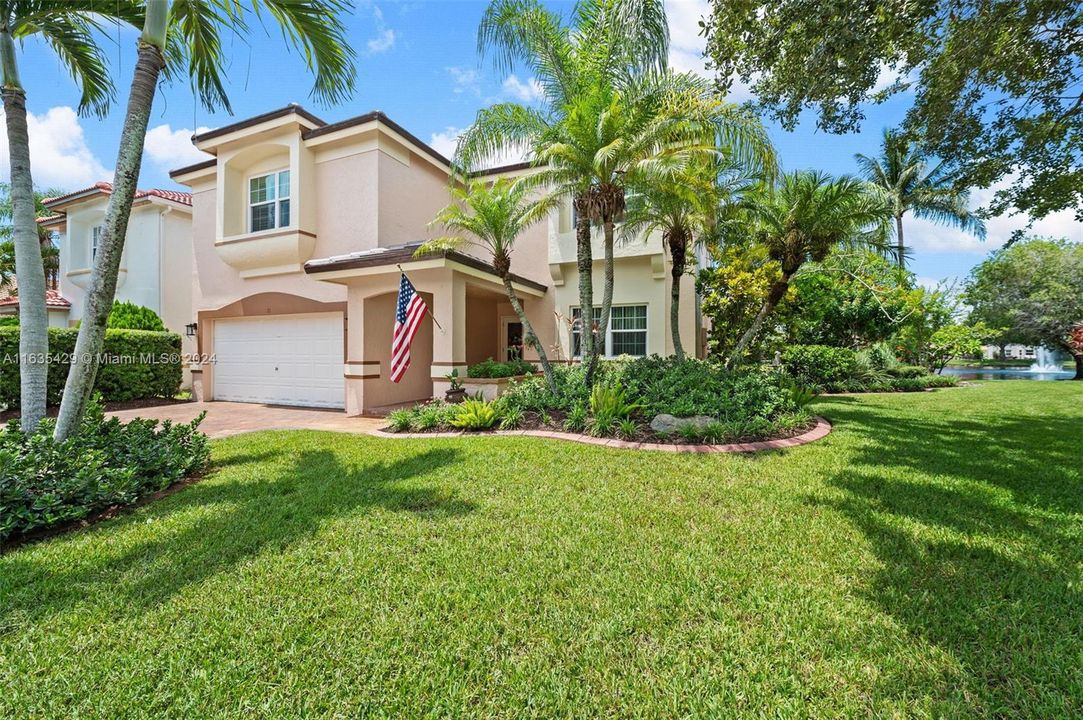 Side view shows large lot (privacy) and lush landscaping.