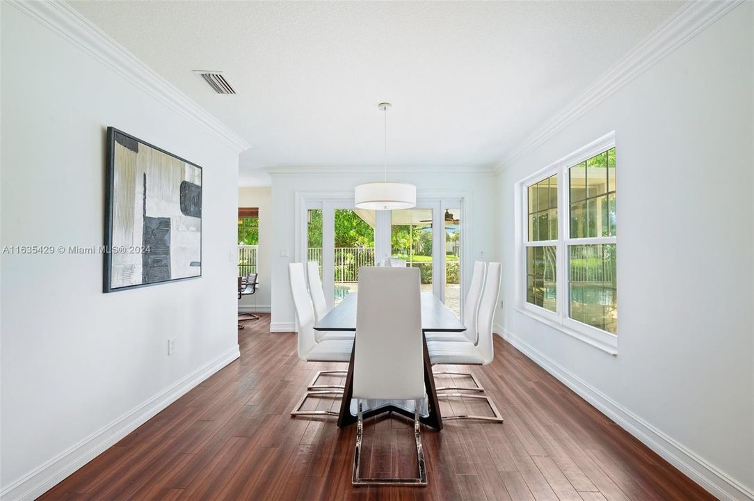 Formal Dining Room Overlooking Lake, Pool and Patio.