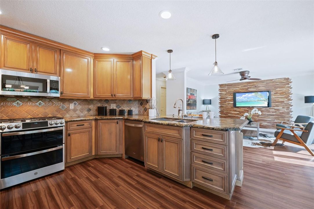 Kitchen with breakfast bar overlooks the family room.