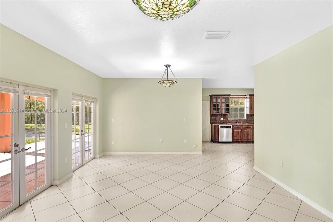 This family room is perfect for entertaining, it opens to an expansive covered terrace and backyard.