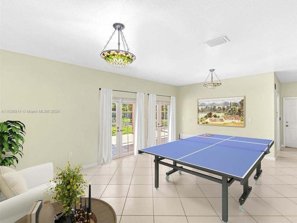 This family room is perfect for entertaining, it opens to an expansive covered terrace and backyard. Virtually Staged photo.