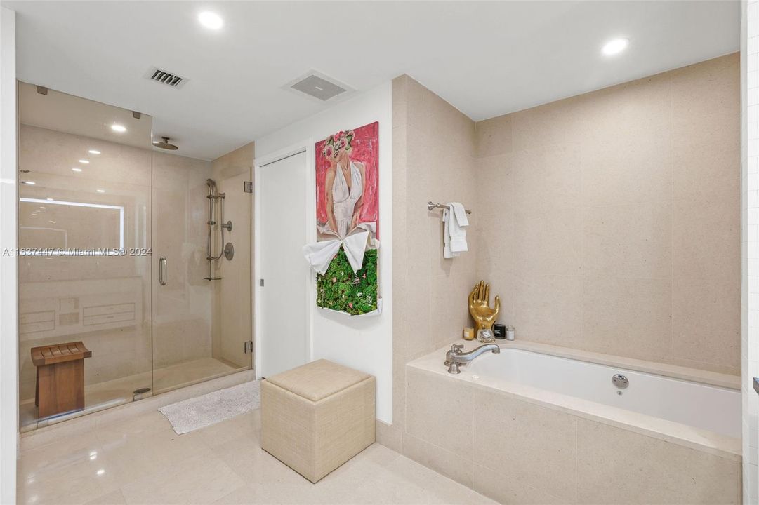 Primary bathroom with separate shower and spa tub