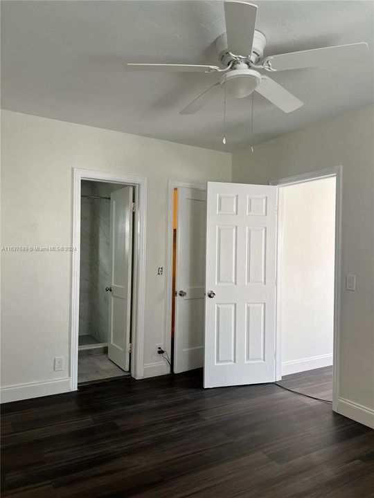 Bedroom of 1 bedroom house with view of bathroom, closet door, and exit to main living area